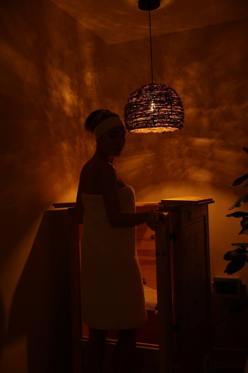 Client beside the open herbal steam sauna at LIMFAERA