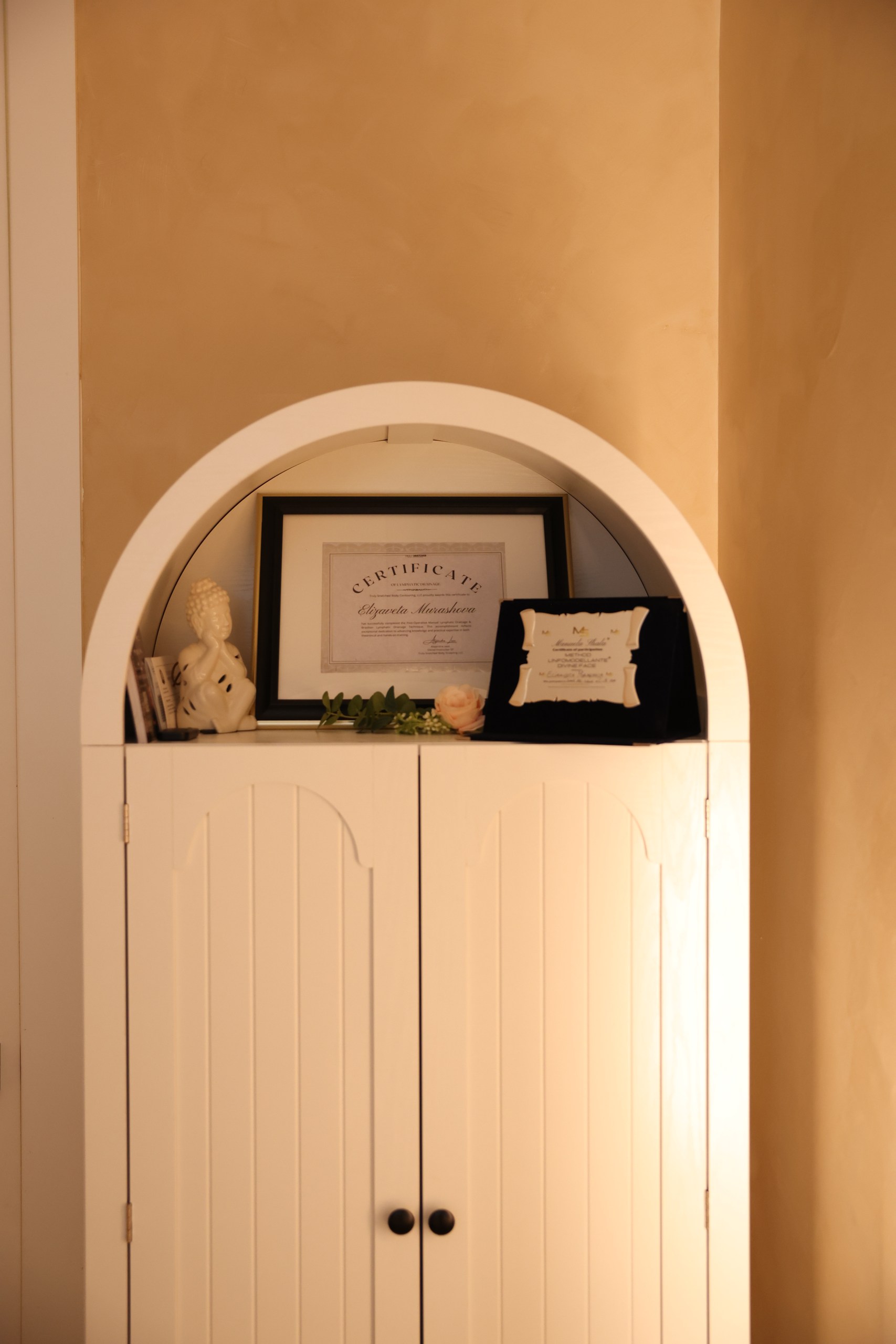 Elizaveta’s framed professional training certificates at LIMFAERA