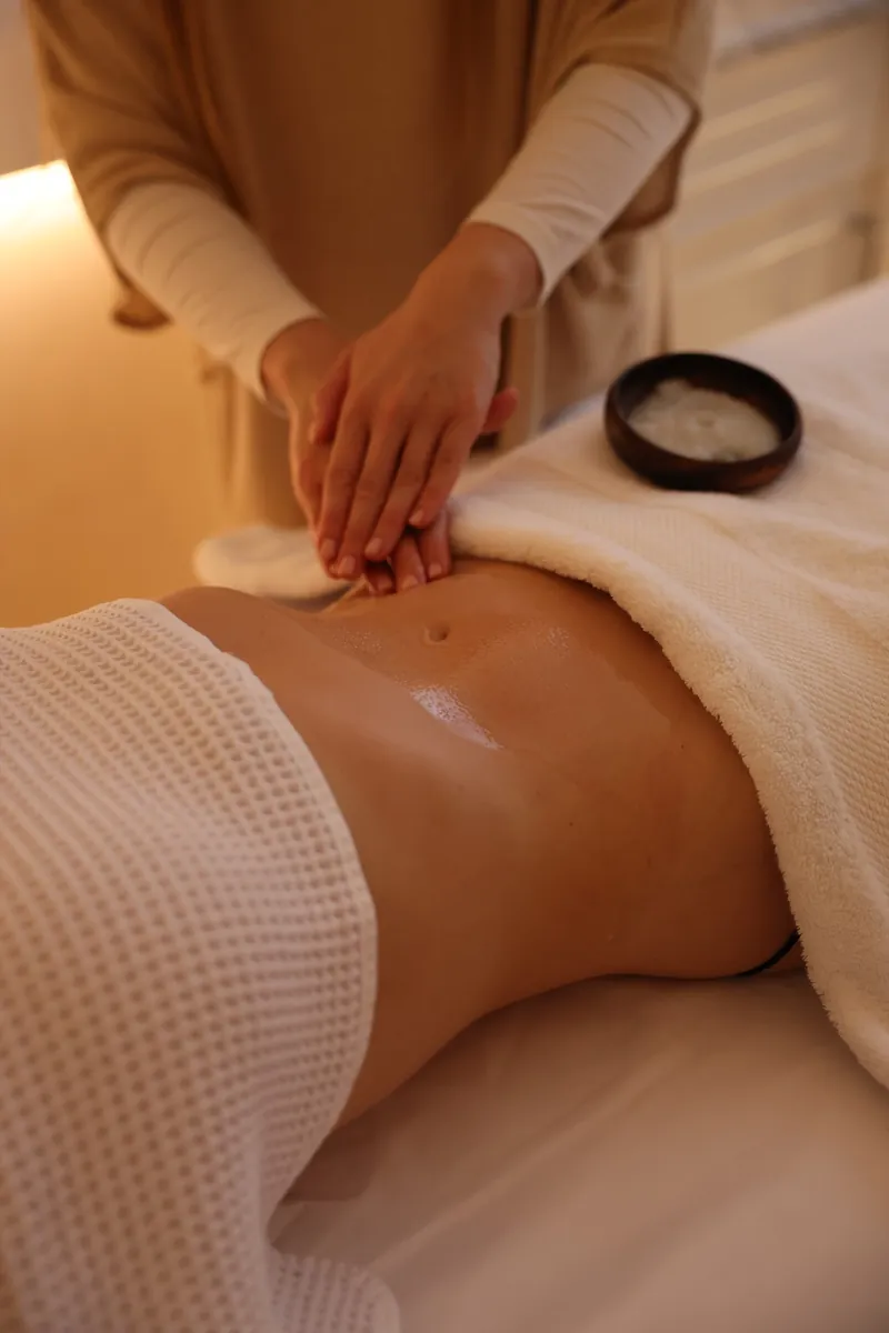 Close-up of hands-on abdominal massage at LIMFAERA